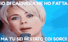 a woman crying while holding a microphone with the words io di carriera ne ho fatta