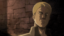 a close up of a man 's face in front of a brick wall