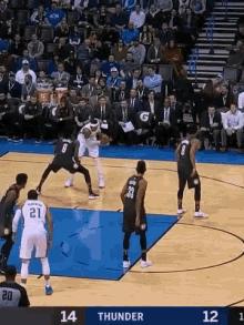 a basketball game is being played between the thunder and the nets .