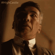a close up of a man 's face with the hashtag #highcastle on the bottom