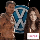 a man and a woman stand in front of a vw logo