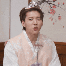 a young man wearing a tiara and a kimono