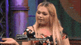 jerry springer is talking to a woman on a tv show