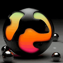 a black ball with a rainbow colored center is surrounded by smaller balls