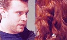a man and a woman are looking at each other with a abc logo in the corner