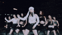 a group of girls are dancing in front of a grocery store that says lunch