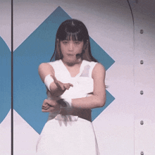 a woman in a white dress is pointing her finger at something