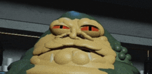 a close up of a jabba the hutt statue