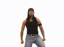 a man wearing a black tank top and blue jeans is dancing