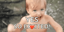 a baby without a shirt is standing in the water and smiling .