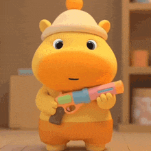 a stuffed animal wearing a hat and holding a toy gun