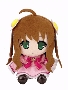a stuffed toy of a girl with brown hair and green eyes