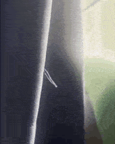 a close up of a curtain with a hole in the middle