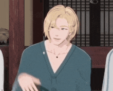a man with long blonde hair is wearing a blue kimono and a necklace .