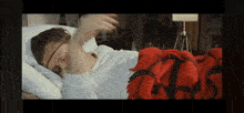 a woman is laying in bed with a red blanket and a vimeo logo in the corner