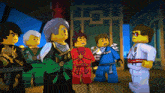 a group of lego figures are standing in a room
