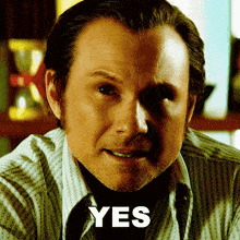 a close up of a man 's face with the word yes in the corner