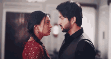 a man and a woman looking at each other with their eyes closed