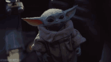 a close up of a baby yoda with the hashtag tannerfrizzell on the bottom