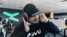 a man wearing headphones and a beanie with the word multivox written on it