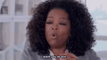 oprah winfrey is blowing a kiss and saying `` i want you to win . ''
