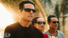 a movie poster for mission impossible 3 shows a man and two women wearing sunglasses
