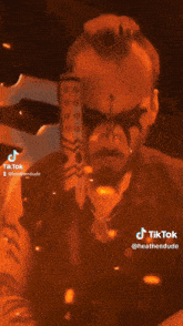 a person wearing a helmet and holding a large axe with tiktok written on the bottom right corner