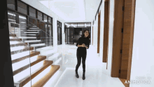a woman is standing in a hallway with stairs made in animonica