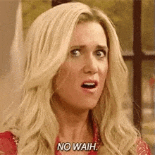 a blonde woman is making a funny face and saying no waih .