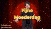 a man in a suit stands in front of a red curtain with the words fijne moederdag above him