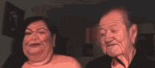a man and a woman are looking at each other in a dark room