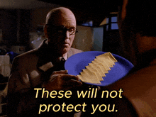 a man holding a plate of cheese with the words " these will not protect you " above him