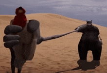 a person in a red hood is standing next to a giant robot