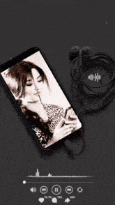 a phone with a picture of a woman on the screen is playing arabic music