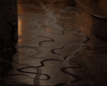 a person walking down a hallway with a snake pattern on the floor