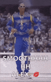 snoop dogg is dancing in front of a crowd while wearing sunglasses and a blue shirt .