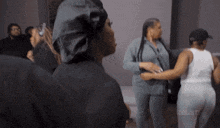 a group of women are standing in a room with the word reuse on the bottom right