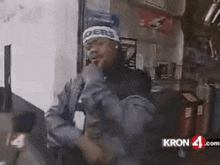 a man wearing a pepsi headband is dancing