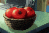 a basket of apples sits on a desk in front of a computer keyboard