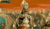 a man in a costume with a mustache is standing in front of a crowd of people .