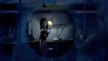 a cartoon character is standing in front of a desk with a lamp .