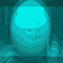 a statue of an egg with a face and a hand waving