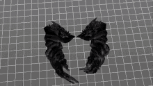 a computer generated image of a pair of black wings on a grid background