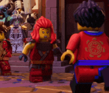 a group of lego ninjago characters are standing next to each other on a sidewalk .