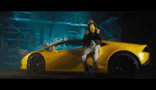 a man wearing a mask is leaning on a yellow sports car