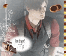 a man in a suit and tie is standing next to a box of chocolates and cookies .