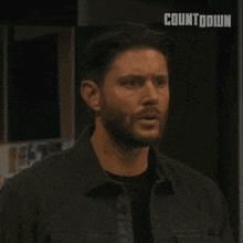 a man with a beard says holy shit in front of a woman