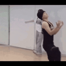 a couple of men are dancing in a room .