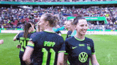 a group of female soccer players one of whom has the name popp on the back of her jersey