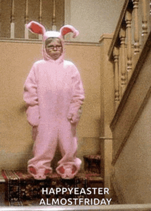 a person in a pink bunny costume with the words happyeaster almost friday